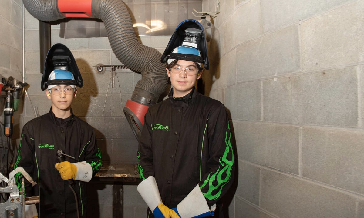Two students about to weld