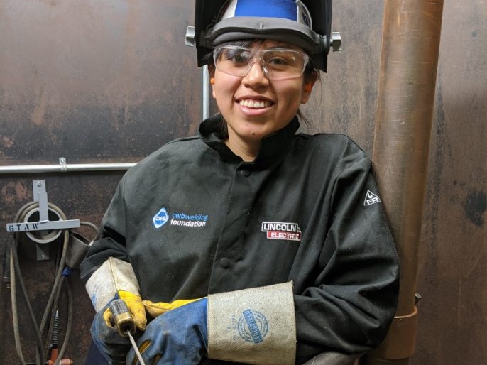 Smiling welder woman