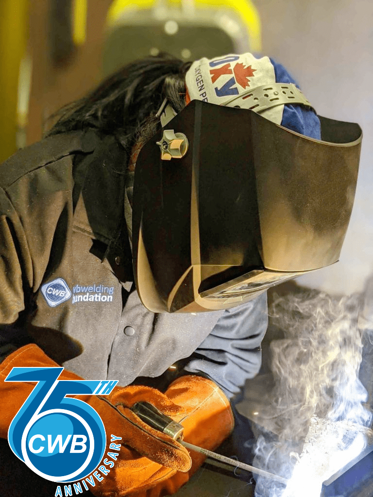 Girl welding wearing welding equipment